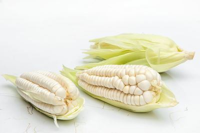 Close-up of bread on table against white background