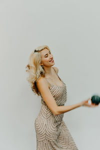 Woman standing against white background