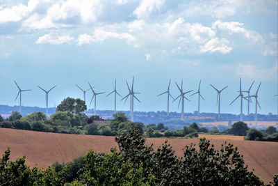 Windmill on field against sky