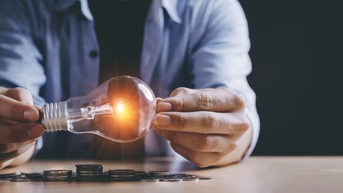 Close-up of hand holding crystal ball on table