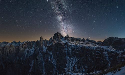 Scenic view of mountains against sky at night