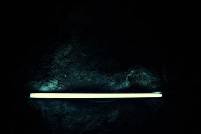 High angle view of illuminated lamp against black background