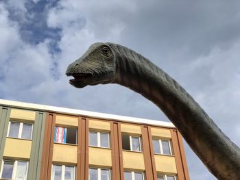 Low angle view of a horse statue against sky