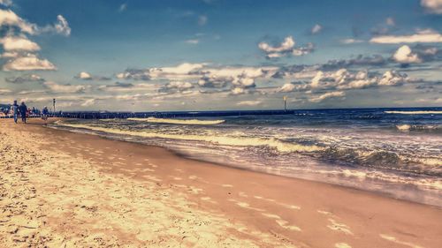 Scenic view of beach against sky during sunset