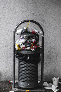 Close-up of garbage bin against wall