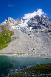 Scenic view of snowcapped mountains against blue sky