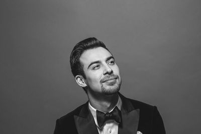 Portrait of young man against gray background