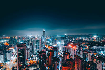 High angle view of city lit up at night