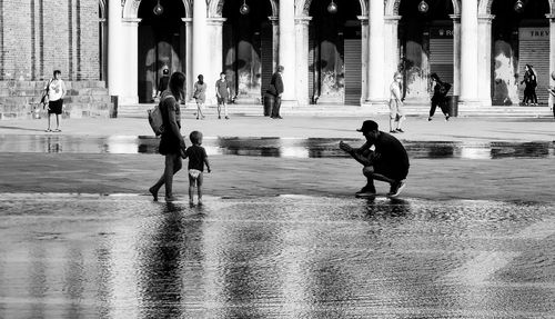 People walking on wet street in rain