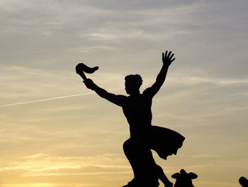 Silhouette of man jumping against sky