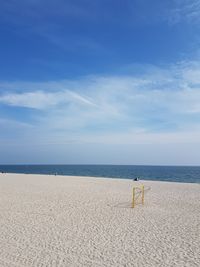 Scenic view of beach against blue sky