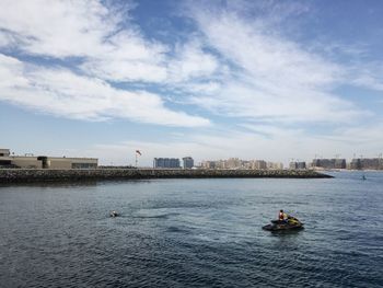 Scenic view of river against sky in city