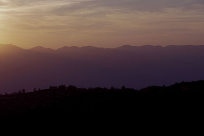 Scenic view of silhouette mountains against sky at sunset