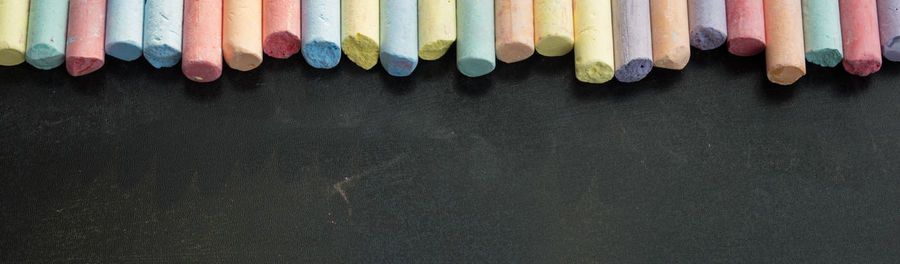 Panoramic view of colorful chalks on table