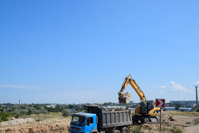 Construction site on field against clear blue sky