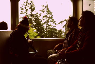 Rear view of woman sitting in bus