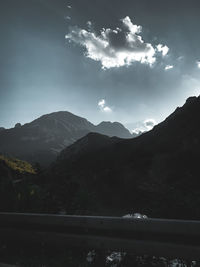 Scenic view of river amidst mountains against sky