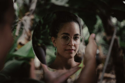 Portrait of a young woman in mirror with glasses