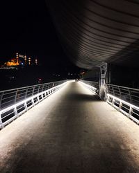 Illuminated bridge in city at night