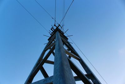 Low angle view of windmill against clear blue sky