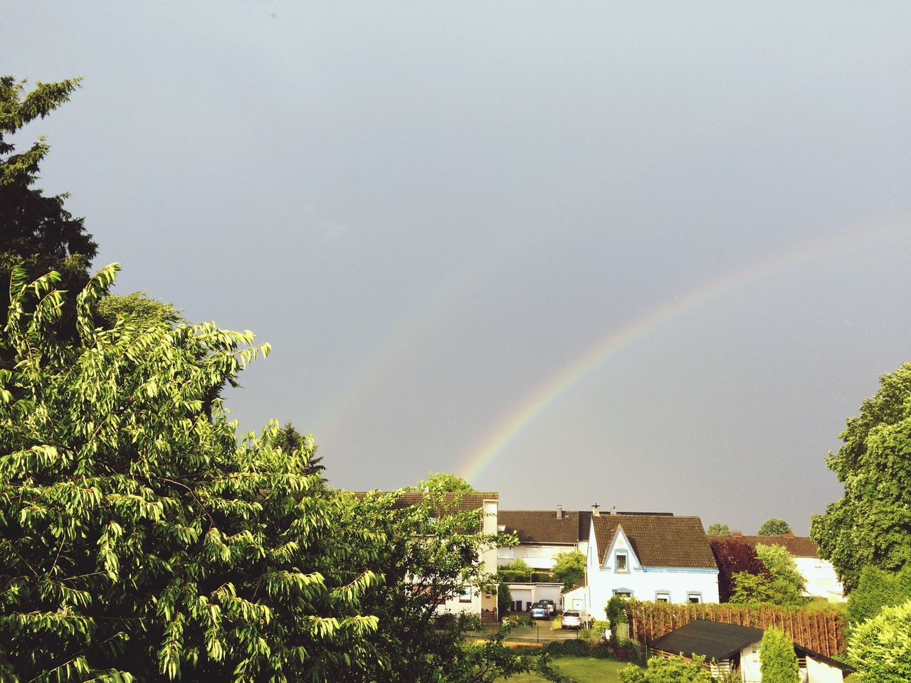 RAINBOW OVER HOUSE AGAINST SKY