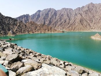 Scenic view of lake and mountains against sky