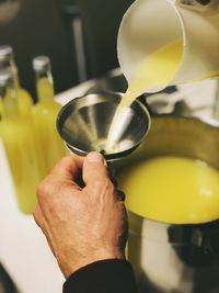 Close-up of man pouring limoncello 