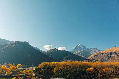 Scenic view of mountains against clear blue sky