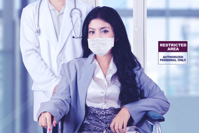 Portrait of young woman standing with text