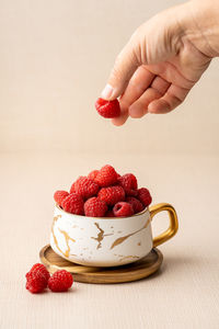 Close-up of hand holding strawberries