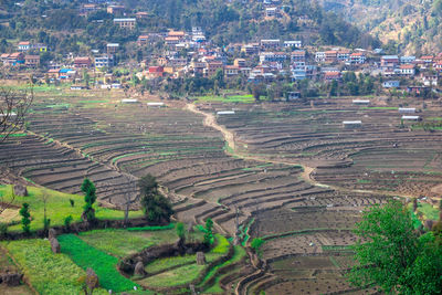 High angle view of agricultural field against buildings