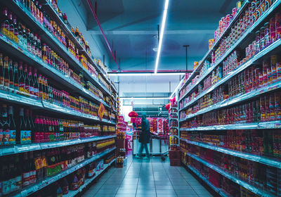 Rear view of people at illuminated store