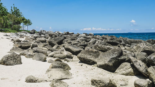 Panoramic shot of rocks on beach against sky