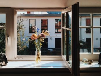 Flower vase on window at home