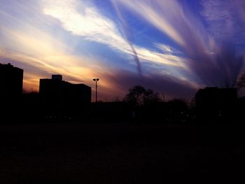 Silhouette of building at sunset