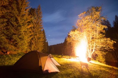 High angle view of illuminated tent against sky at night