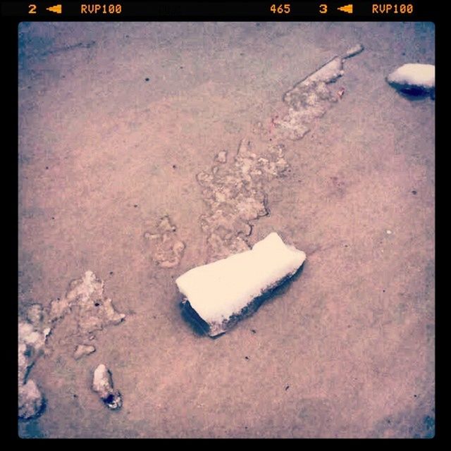 transfer print, auto post production filter, high angle view, white color, sand, no people, ground, day, text, outdoors, close-up, communication, vignette, beach, western script, street, white, still life, abandoned, asphalt