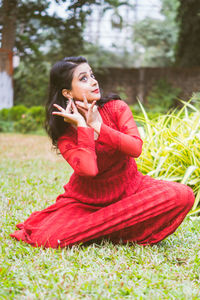 Young woman sitting on field