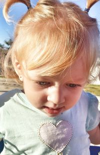 Close-up of cute girl looking down