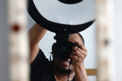 Close-up of man holding camera