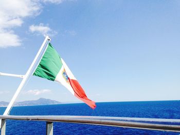 Low angle view of flag on sea against sky