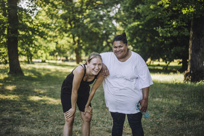 Portrait of happy female friends after doing work out at park