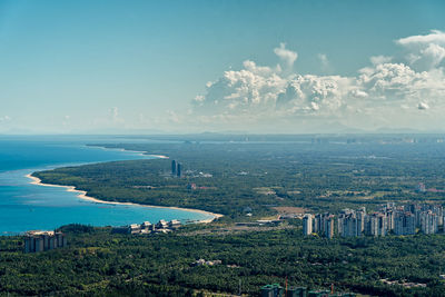 High angle view of city by sea against sky