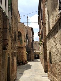 Narrow alley amidst old buildings in city