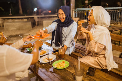 Friends having food at restaurant