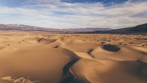 Sand dune in desert against sky