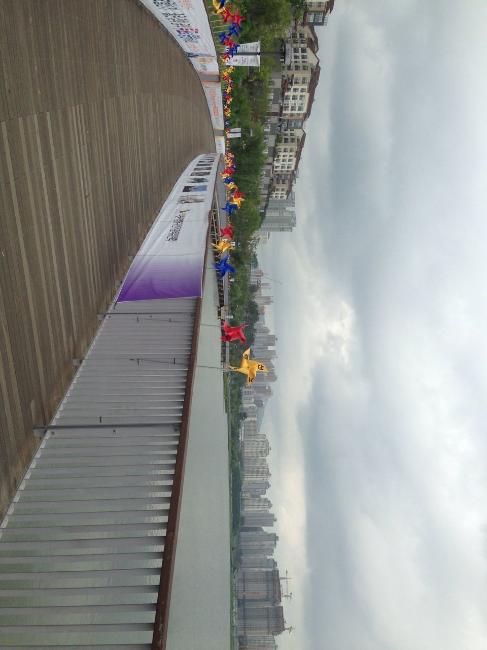 sky, architecture, transportation, built structure, cloud - sky, building exterior, mode of transport, nautical vessel, city, water, cloudy, in a row, travel, river, waterfront, cloud, outdoors, day, incidental people, bridge - man made structure