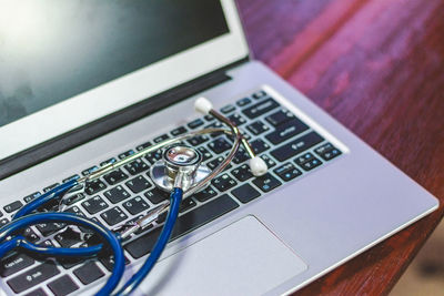 Close-up of stethoscope on laptop at table