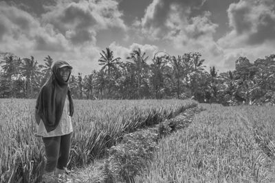 Man standing on field against sky