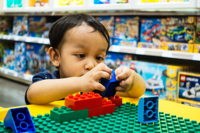 Portrait of boy with toy in store